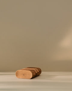 Wooden cutting board holder placed on a kitchen counter