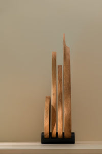 Different sizes wooden cutting boards placed in a black holder