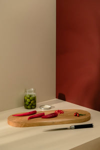 Red chilli peppers placed on the wooden cutting board