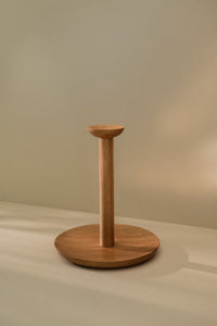 Large wooden paper towel holder placed on a kitchen counter