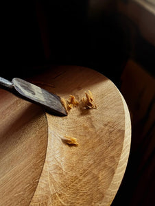 Hands carving wood